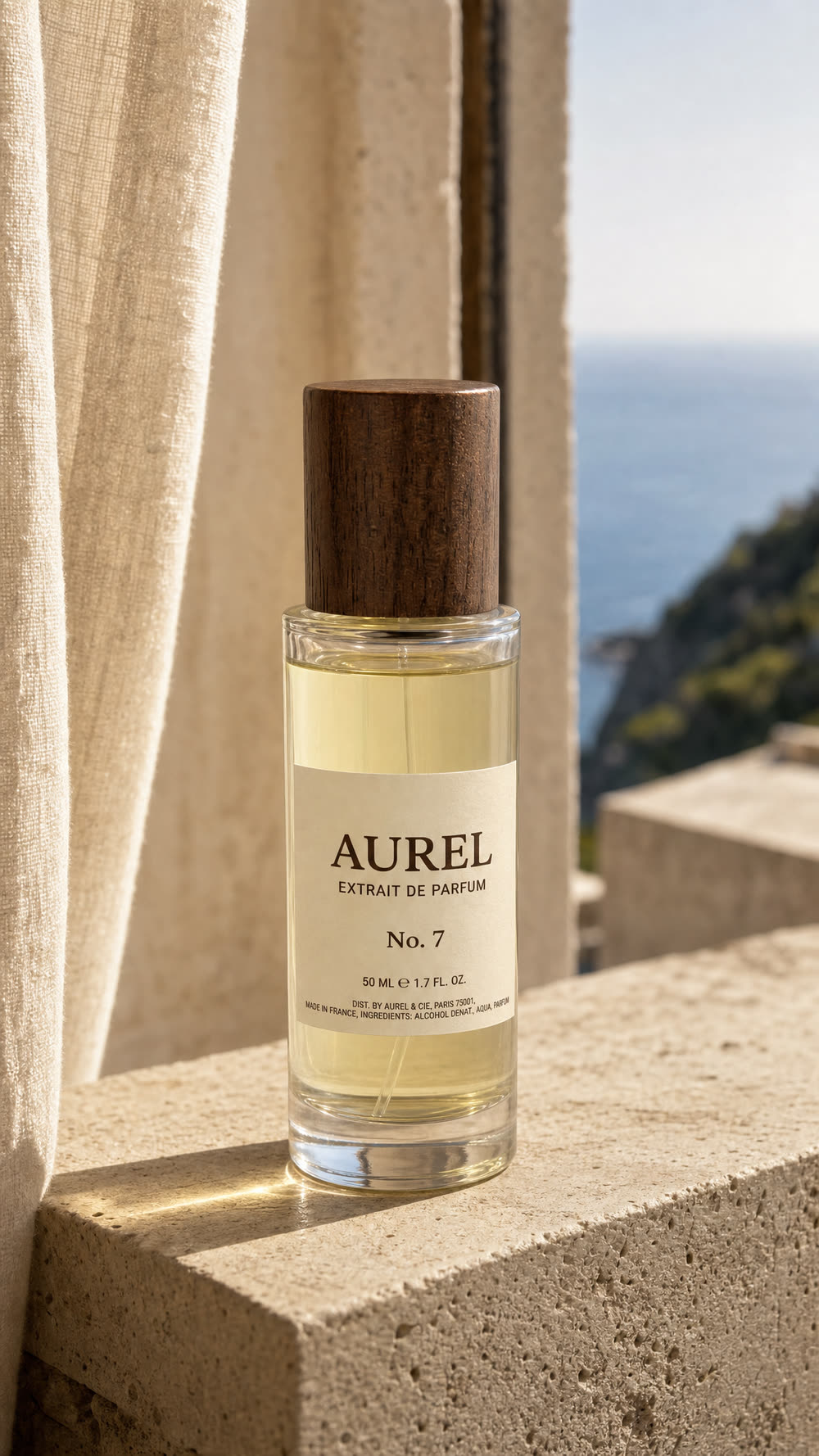 A perfume bottle on a travertine ledge in bright afternoon sun, the sea out of focus behind it.